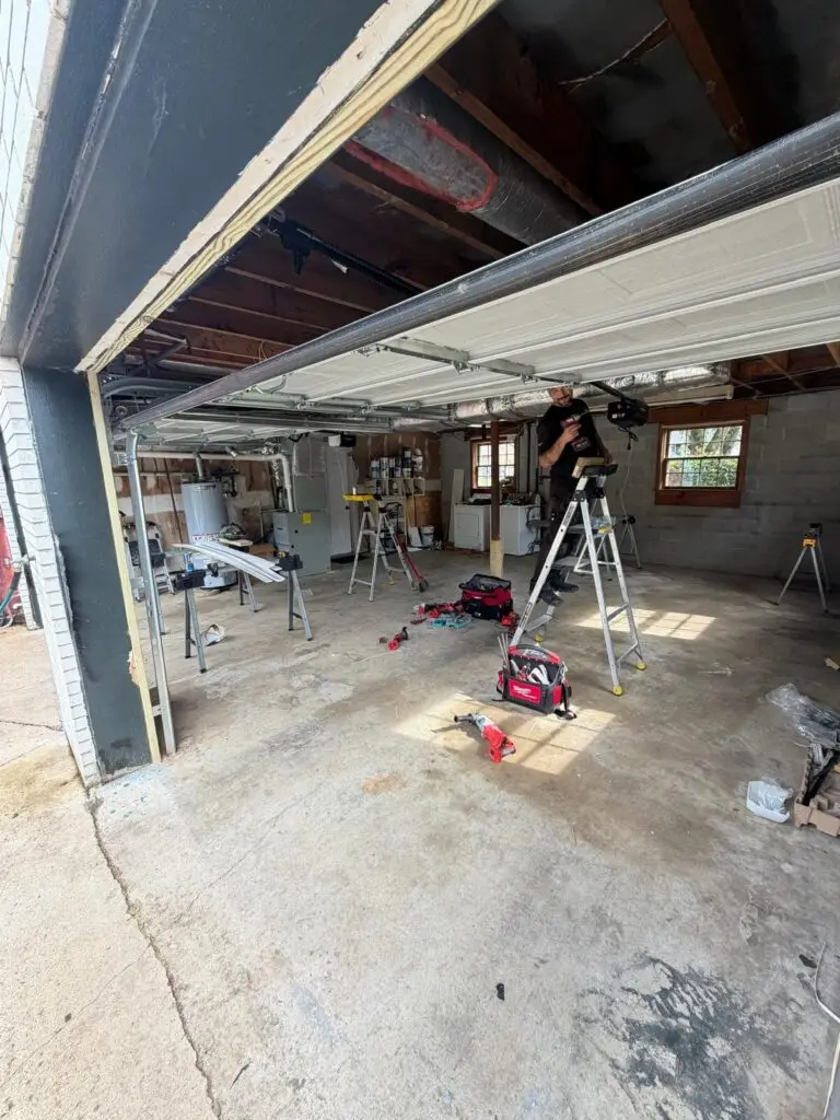 Technician servicing a garage door opener during a repair call